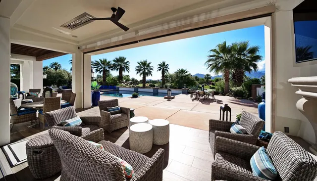 a living room with furniture and chandelier