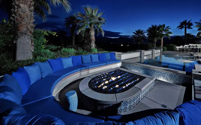 a large kitchen with stainless steel appliances kitchen island granite countertop a sink dishwasher a stove and a dining table with wooden floor