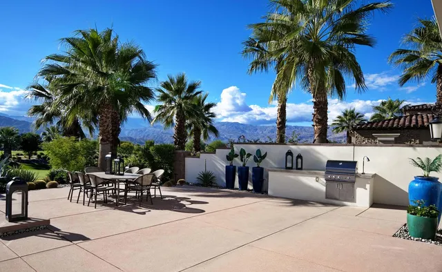a open kitchen with stainless steel appliances granite countertop a sink a stove and a refrigerator