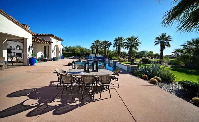 a view of a dining room and livingroom with furniture wooden floor a chandelier