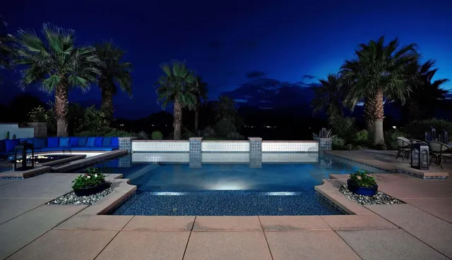 a living room with patio furniture and a flat screen tv