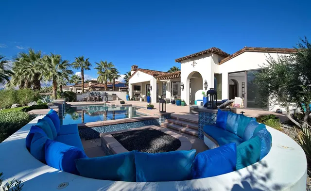 a living room with furniture fireplace and flat screen tv