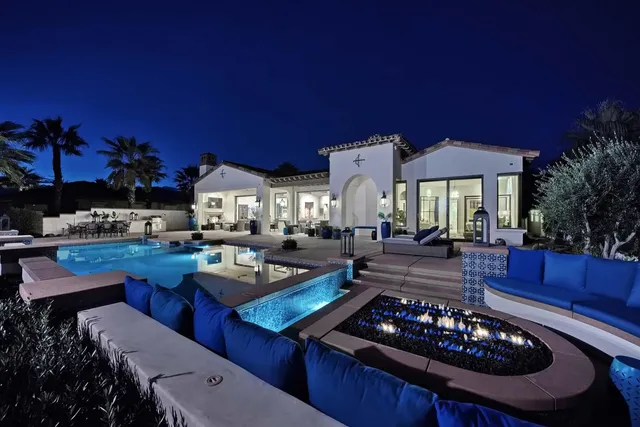 a living room with stainless steel appliances kitchen island granite countertop furniture and a flat screen tv