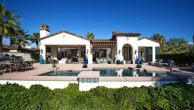 a spacious bedroom with a bed and a chandelier