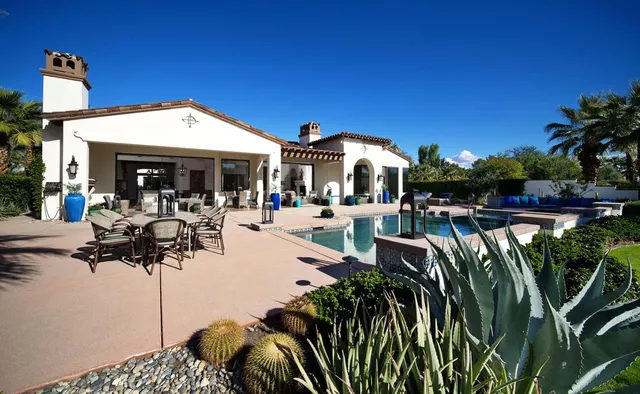 a spacious en suite bathroom with a double vanity sink a mirror a bathtub and a shower
