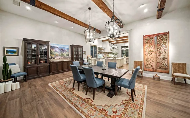 a bedroom with a bed table chair and a window