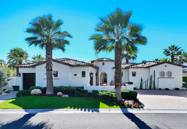 a front view of a house with garden and porch
