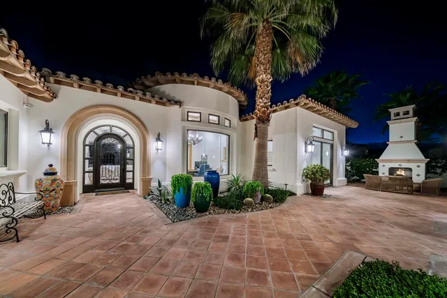 a living room with furniture a large window and wooden floor