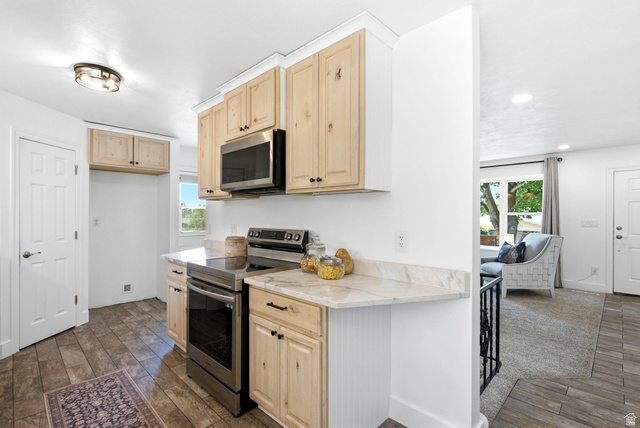 120 North 1230 E Street Springville, UT 84663 - Photo 11 of 60 Kitchen featuring light wood cabinetry, stainless steel oven and microwave, light-toned countertop, and wood-finish flooring
