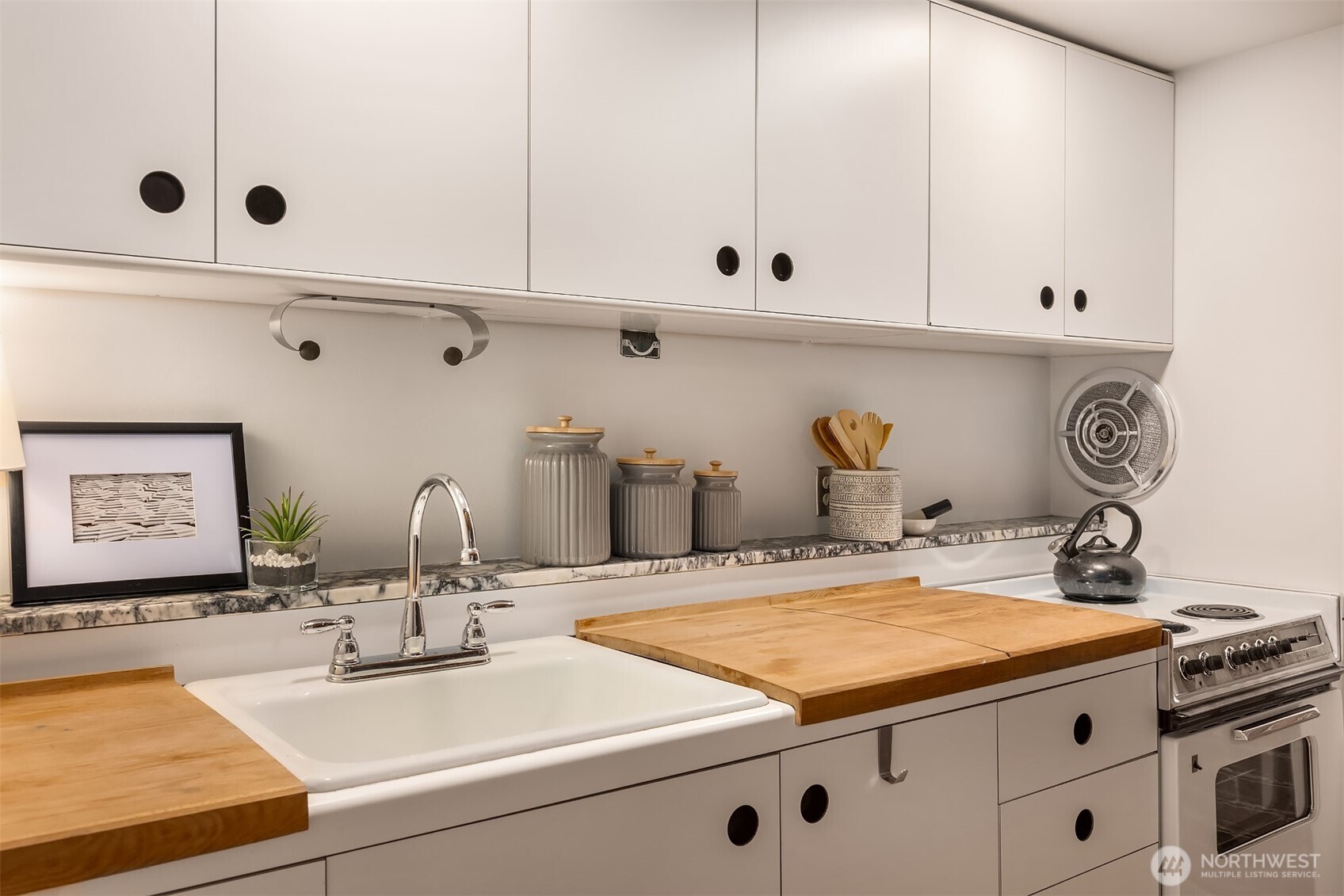 1507 Western Avenue, Unit R501 Seattle, WA 98101 - Photo 5 of 35 a kitchen with kitchen island sink stove and cabinets