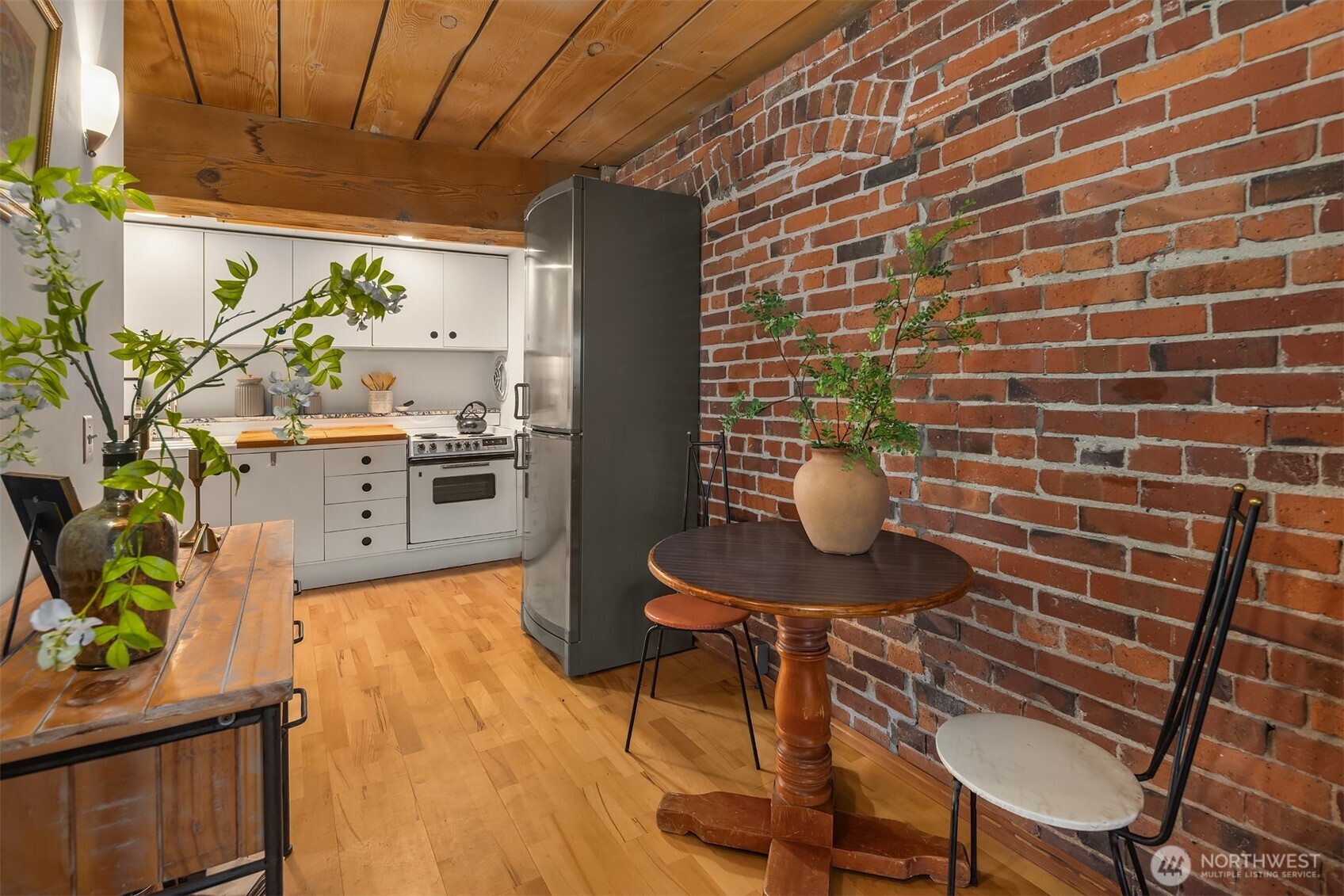 1507 Western Avenue, Unit R501 Seattle, WA 98101 - Photo 6 of 35 a dining room with furniture and a potted plant