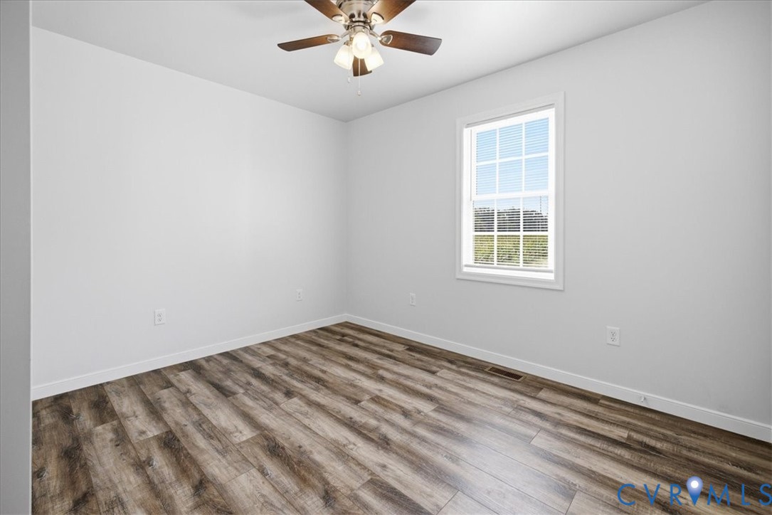 6019 Otterdam Road Waverly, VA 23890 - Photo 21 of 26 Neutral wall paint, wood-finish flooring, white tr