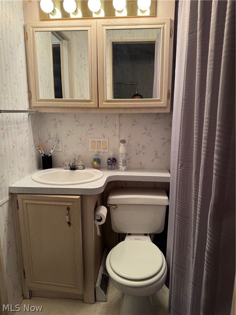17875 Lashley Road, Unit 403 Senecaville, OH 43780 - Photo 14 of 22 Bathroom featuring tile flooring, vanity, and toilet