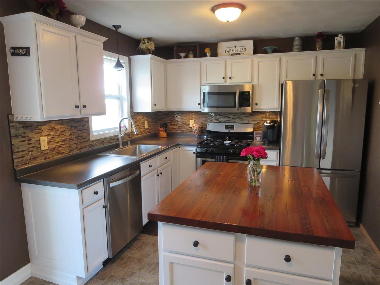 724 Bayfield Road Rockton, IL 61072 - Photo 6 of 22 a kitchen with a sink a stove and refrigerator