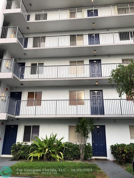 8540 Sherman Circle North, Unit 302 Miramar, FL 33025 - Photo 2 of 18 a front view of residential houses with yard