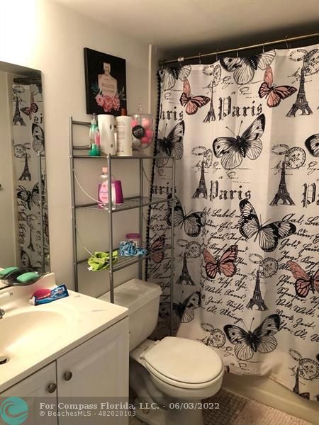 8540 Sherman Circle North, Unit 302 Miramar, FL 33025 - Photo 3 of 18 a bathroom with a toilet and a shower curtain