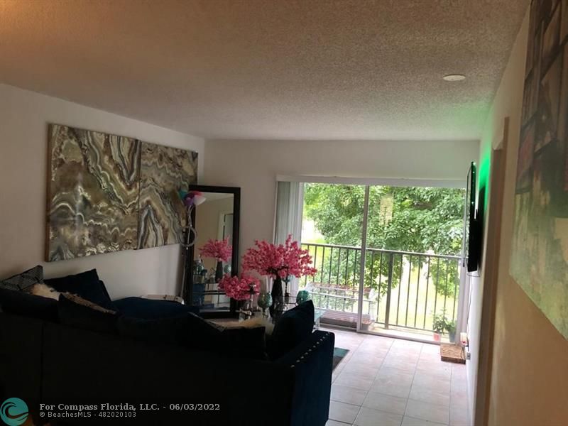 8540 Sherman Circle North, Unit 302 Miramar, FL 33025 - Photo 6 of 18 a living room with furniture and a large window