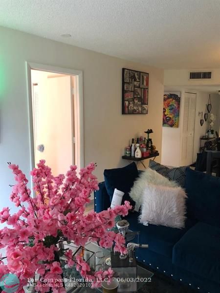 8540 Sherman Circle North, Unit 302 Miramar, FL 33025 - Photo 8 of 18 a bedroom with a bed and a potted plant