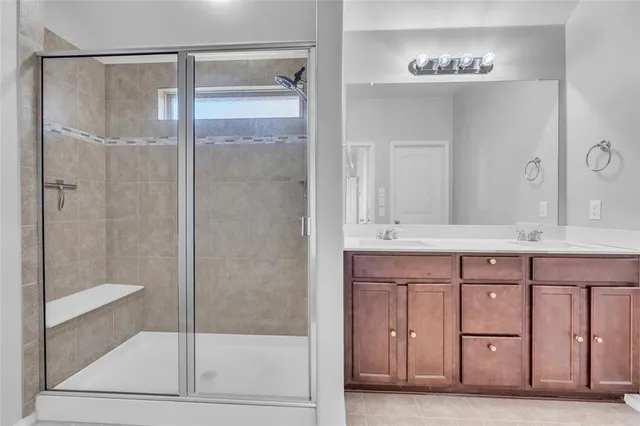 a bathroom with a double vanity sink and a mirror