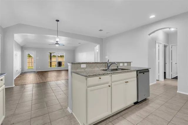 a spacious bathroom with a granite countertop sink a mirror and a vanity