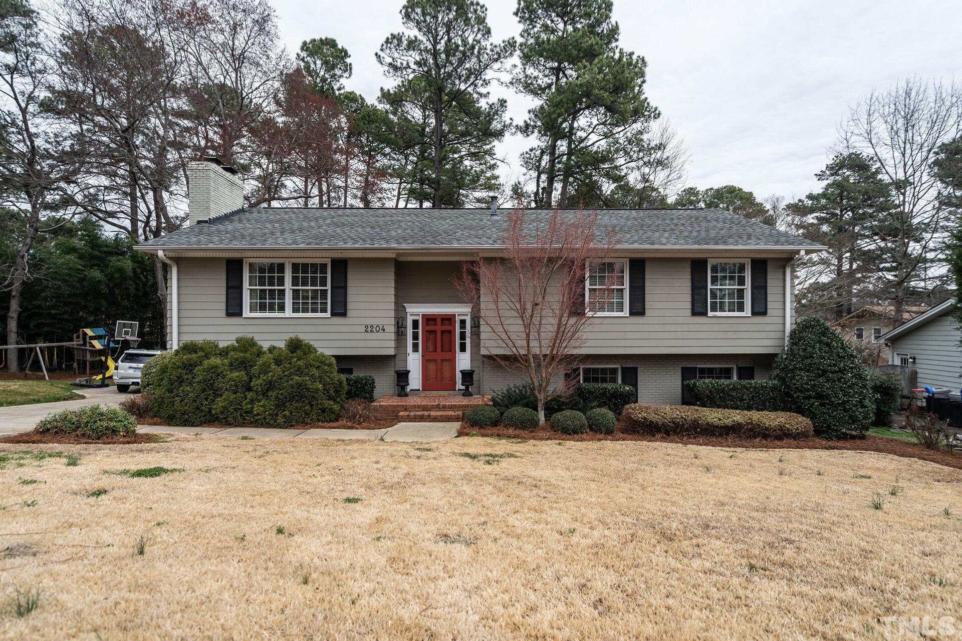 2204 West Charlotte Court Raleigh, NC 27607 - Photo 1 of 31 a view of a house with a yard covered in snow