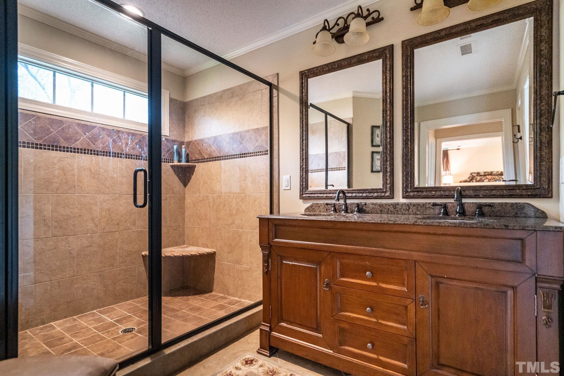 2204 West Charlotte Court Raleigh, NC 27607 - Photo 13 of 31 a bathroom with a granite countertop sink mirror and double