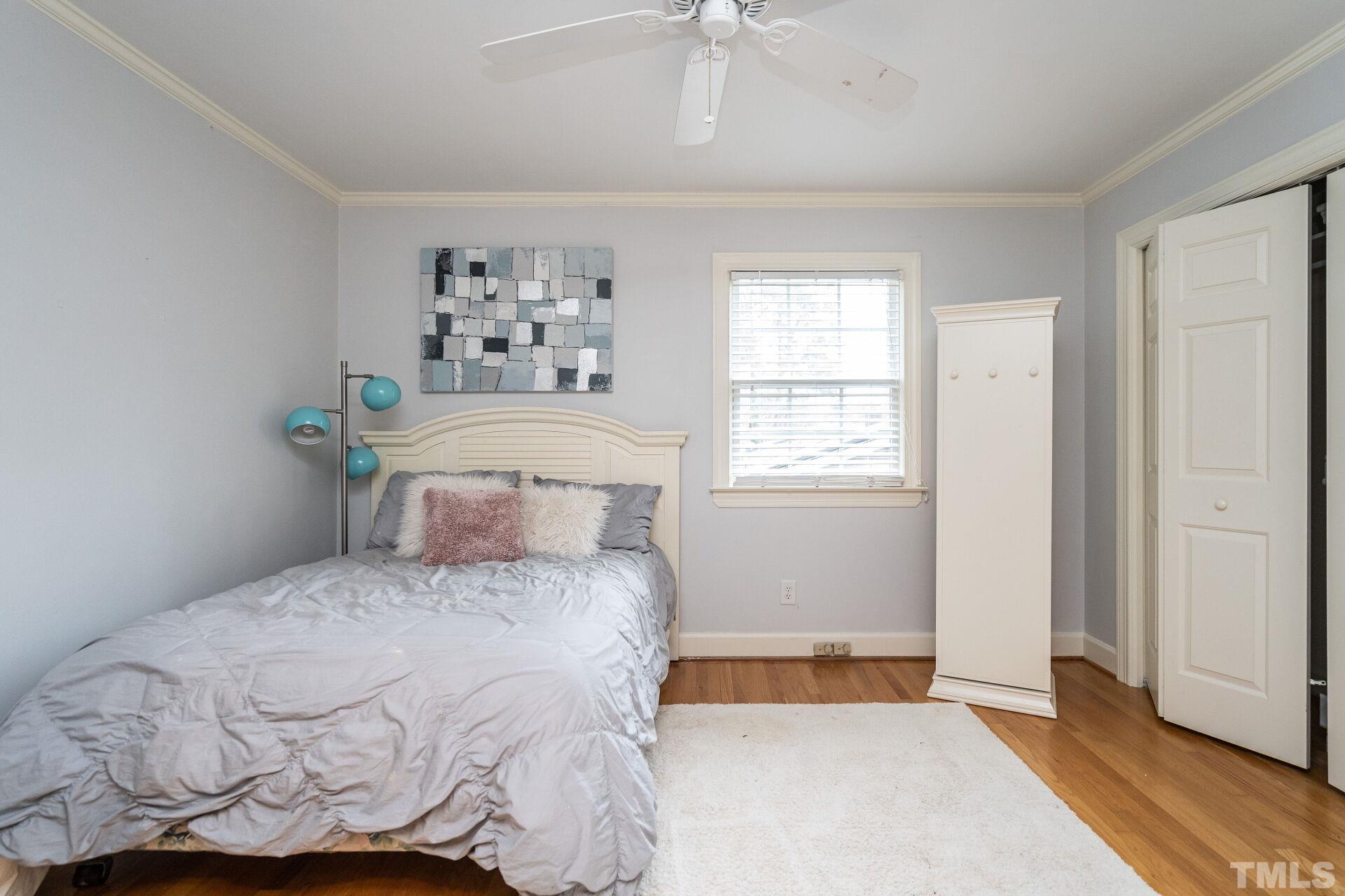 2204 West Charlotte Court Raleigh, NC 27607 - Photo 17 of 31 a bedroom with a bed and a window
