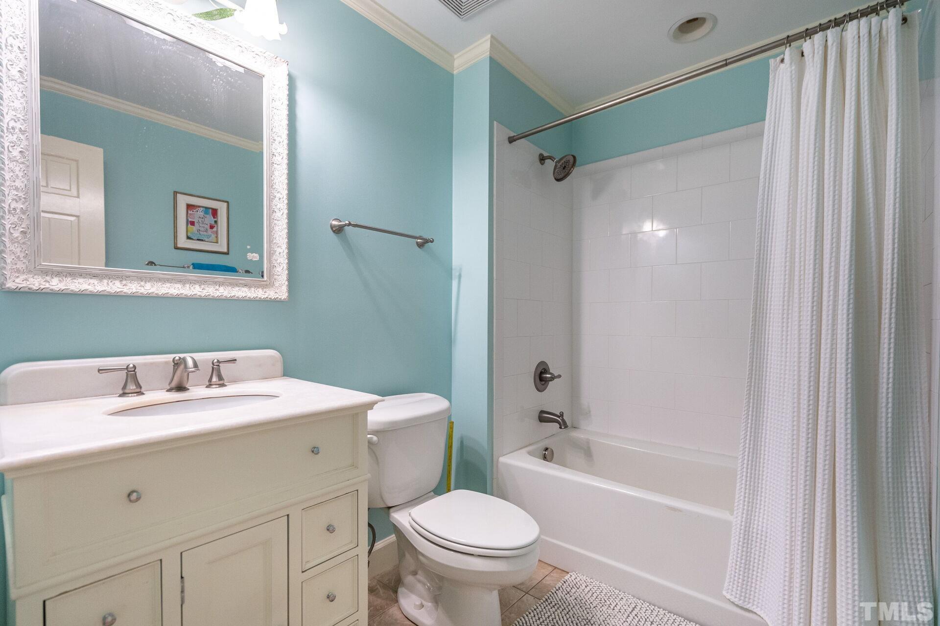 2204 West Charlotte Court Raleigh, NC 27607 - Photo 18 of 31 a bathroom with a sink toilet and shower