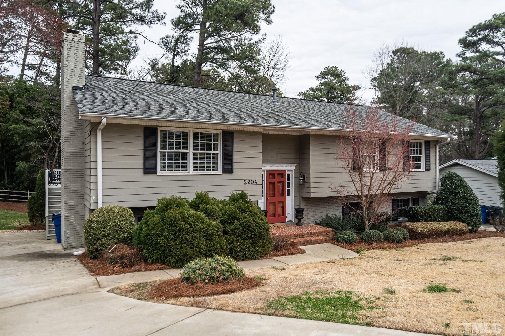 2204 West Charlotte Court Raleigh, NC 27607 - Photo 2 of 31 a front view of a house with a yard