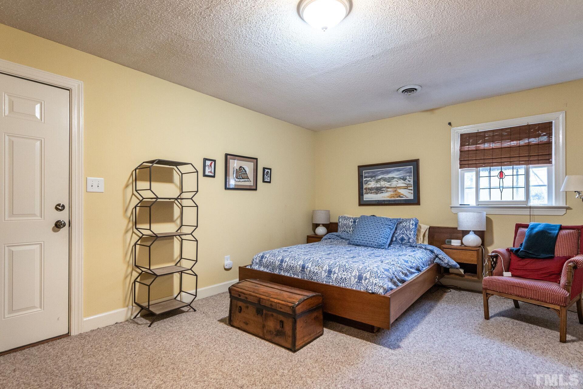 2204 West Charlotte Court Raleigh, NC 27607 - Photo 22 of 31 a bedroom with a bed and a window