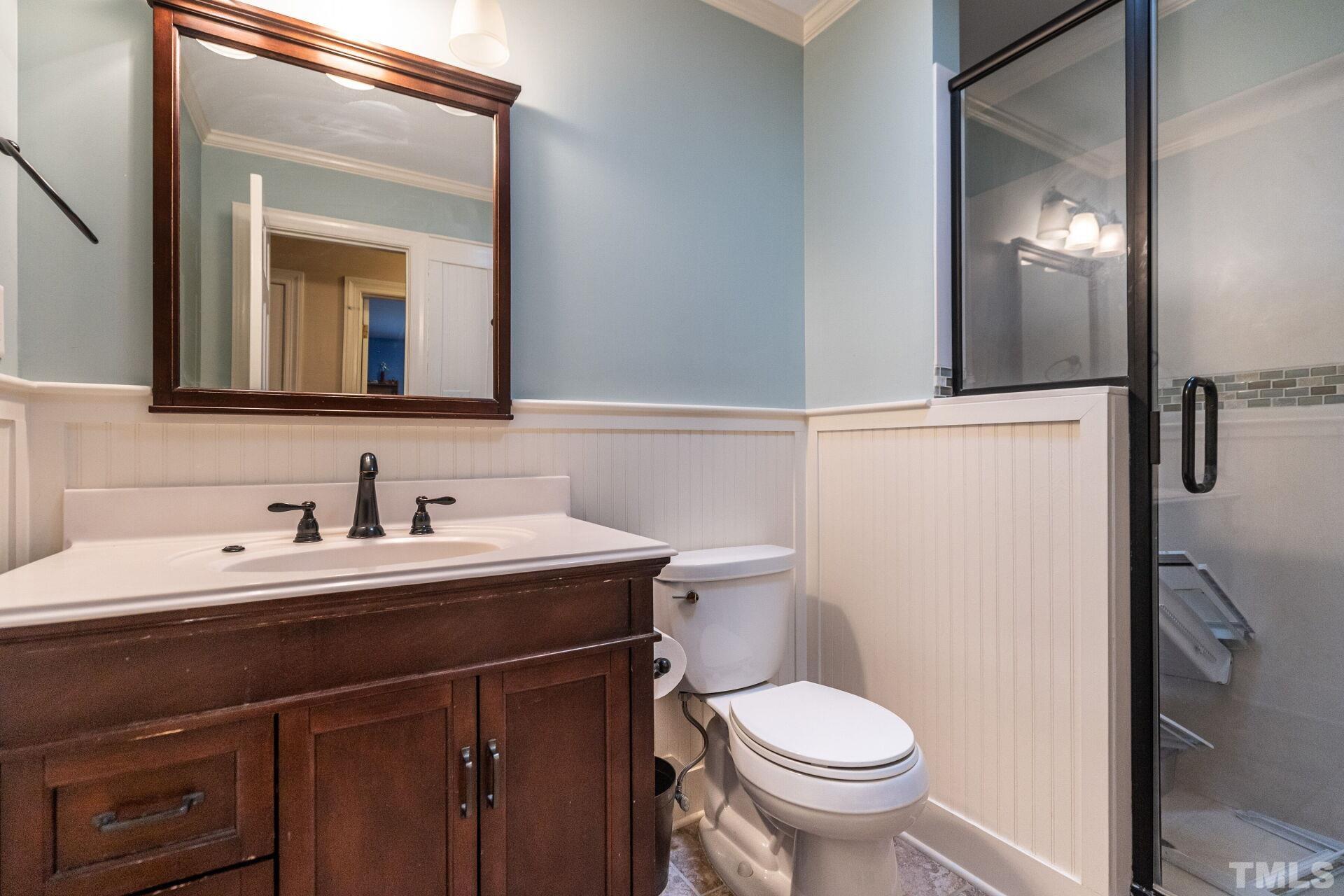 2204 West Charlotte Court Raleigh, NC 27607 - Photo 23 of 31 a bathroom with a toilet sink and mirror