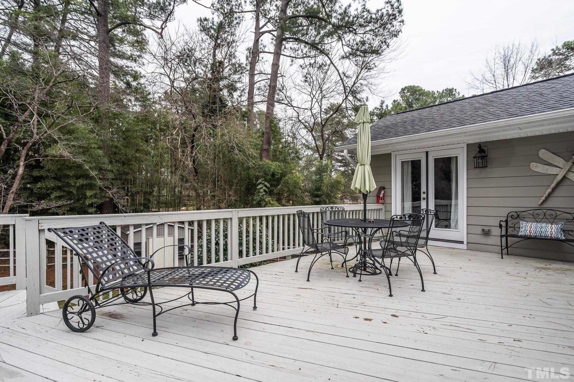 2204 West Charlotte Court Raleigh, NC 27607 - Photo 24 of 31 a view of a patio with a table chairs and wooden fence
