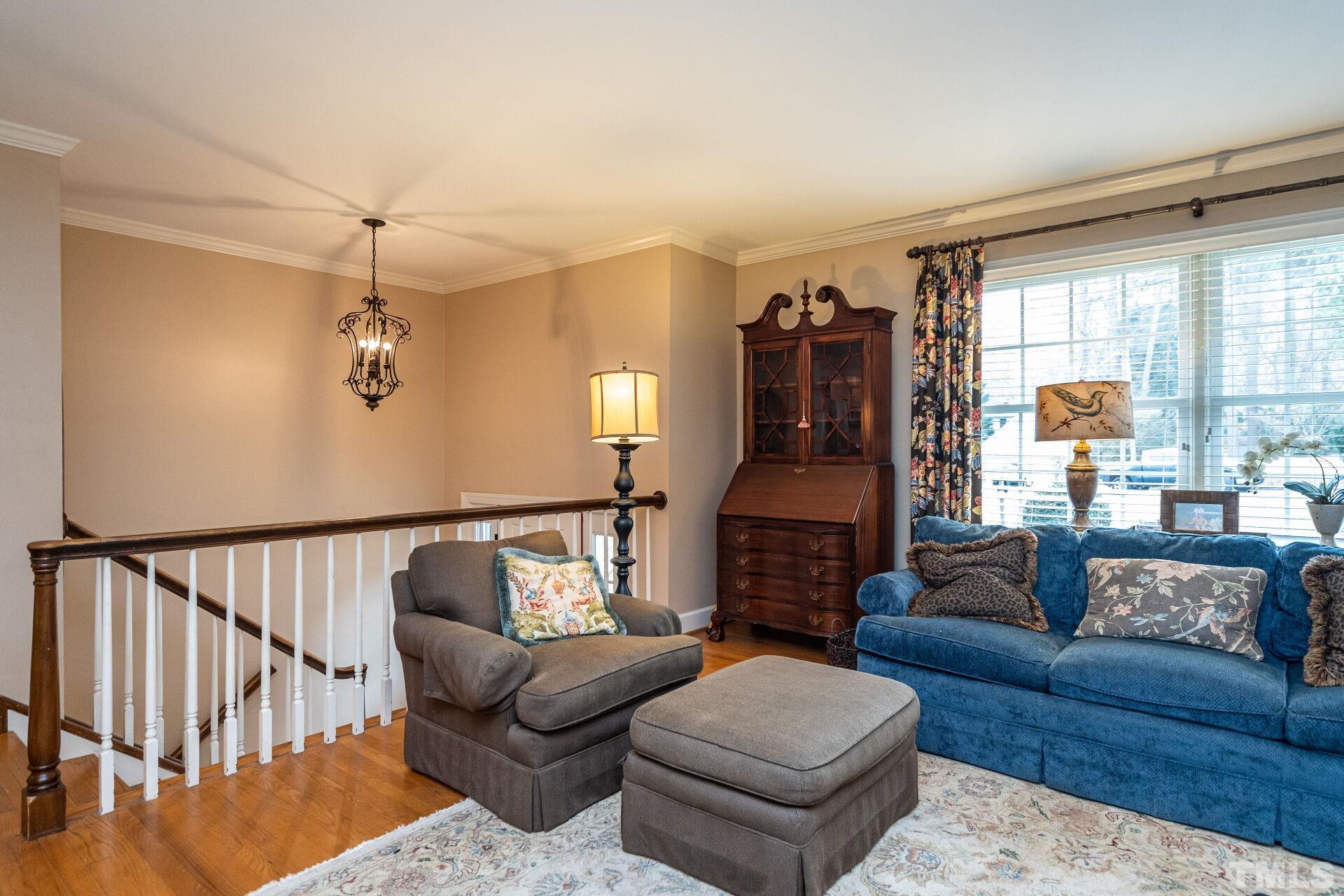2204 West Charlotte Court Raleigh, NC 27607 - Photo 5 of 31 a living room with furniture and wooden floor