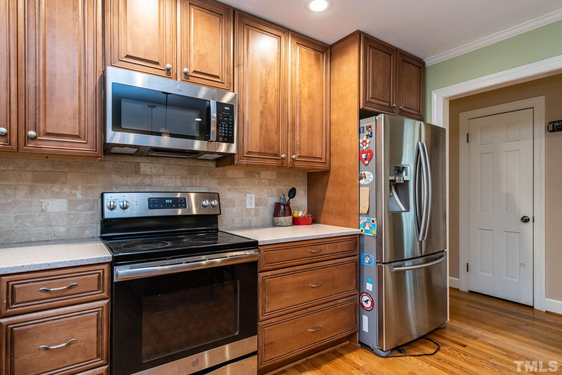 2204 West Charlotte Court Raleigh, NC 27607 - Photo 10 of 31 a kitchen with a refrigerator stove and microwave
