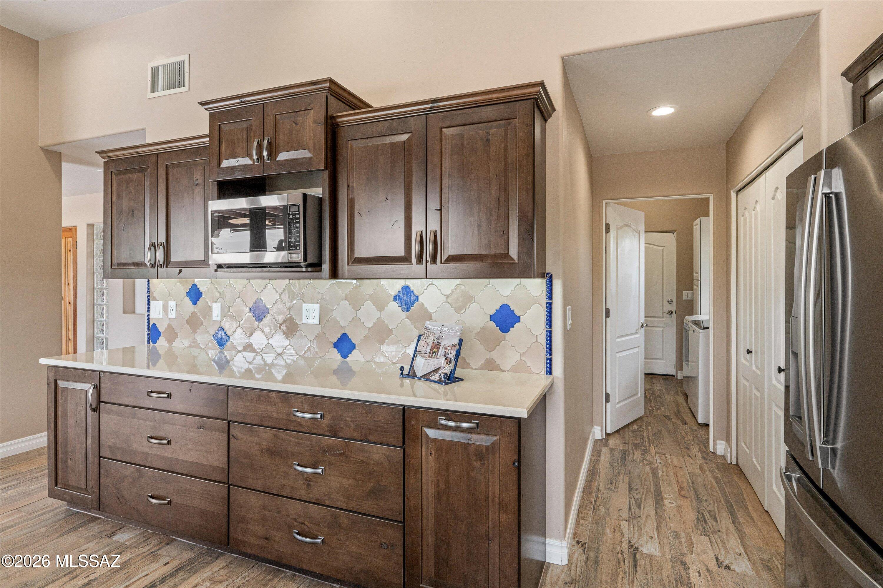 4760 East Wagon Train Road Tucson, AZ 85739 - Photo 22 of 38 a kitchen with stainless steel appliances a refrigerator and a stove