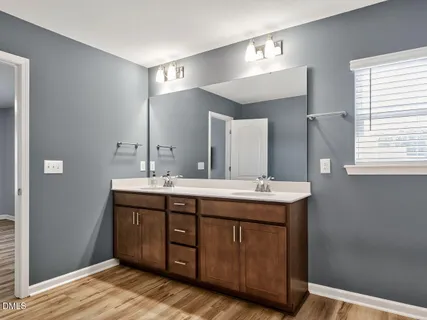 a bathroom with a double vanity sink and a mirror
