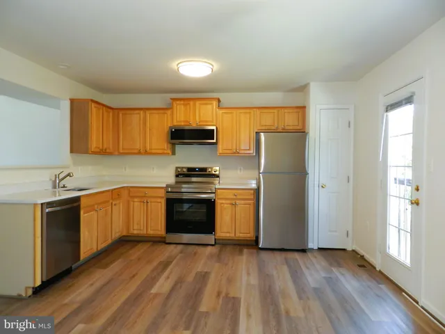 a kitchen with a refrigerator and a sink