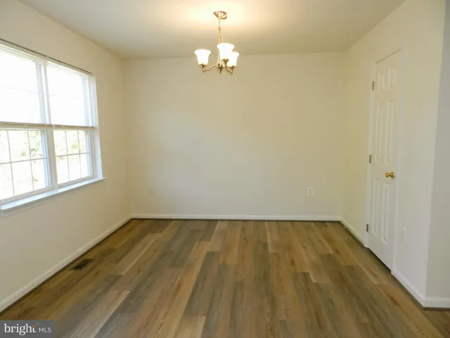 a view of a room with wooden floor and natural light