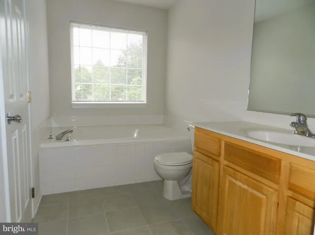 a bathroom with a sink a toilet and bathtub