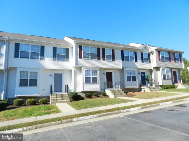 a front view of building with a yard