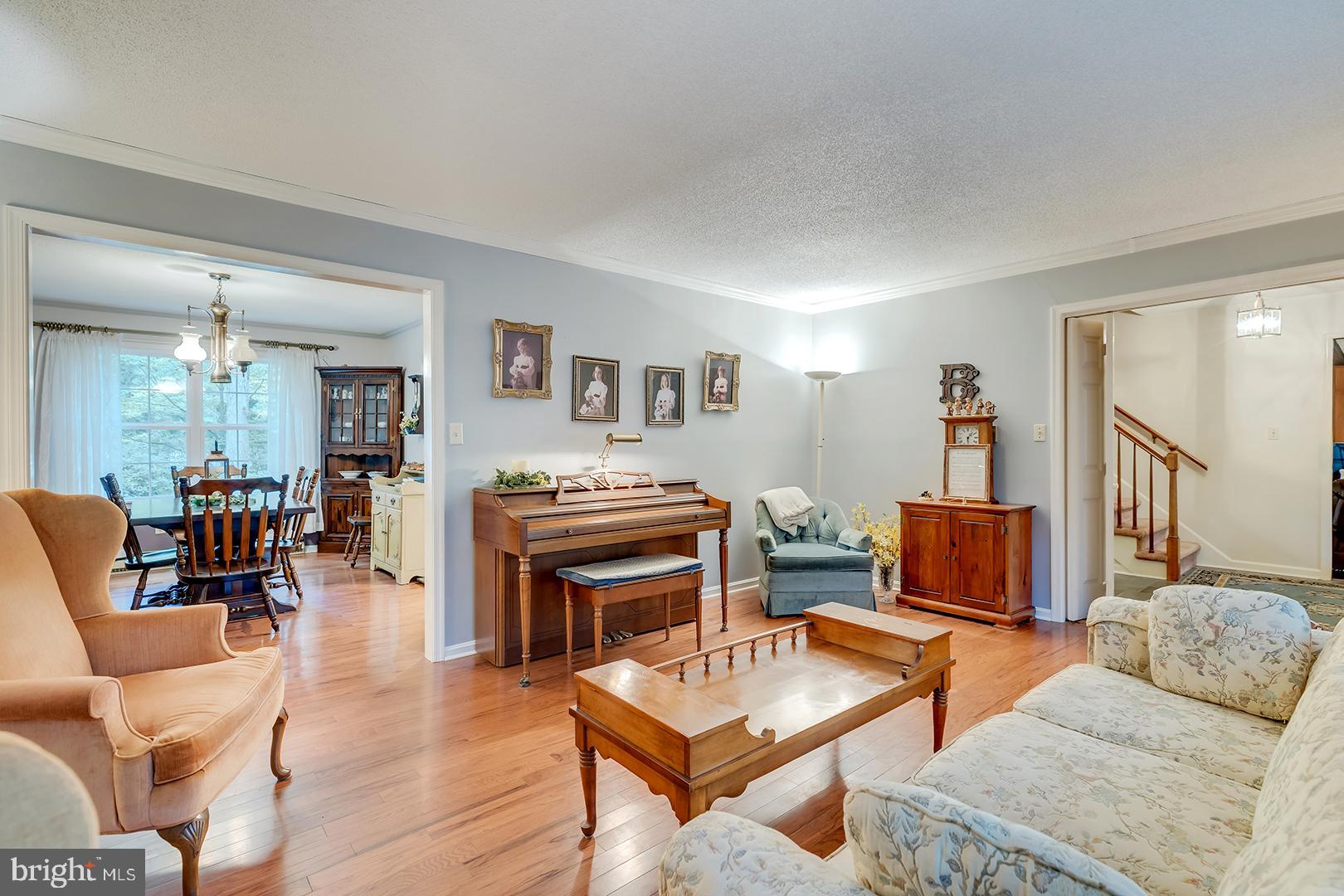 3910 5 Friars Road Salisbury, MD 21804 - Photo 12 of 45 a living room with furniture and a dining table with wooden floor