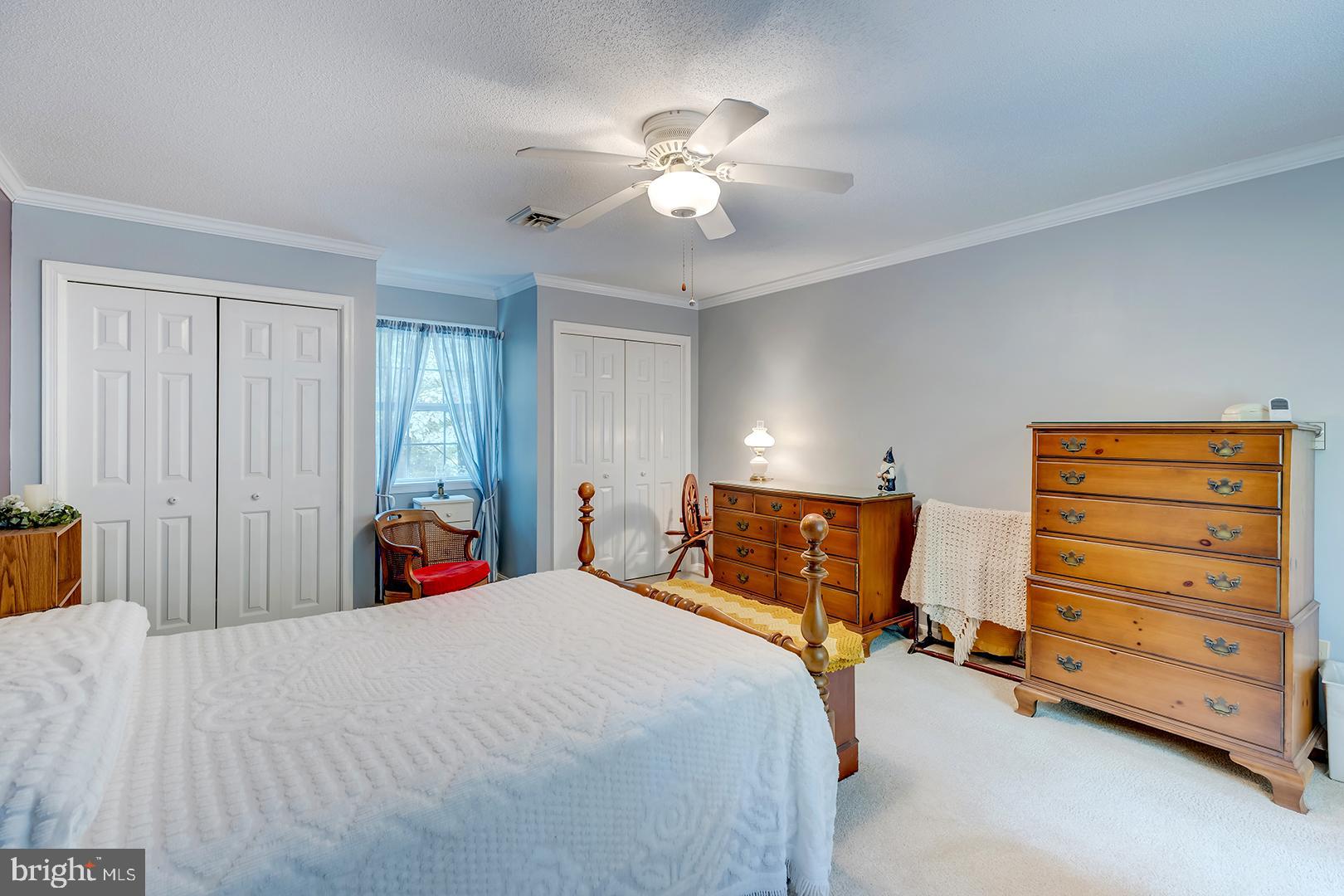 3910 5 Friars Road Salisbury, MD 21804 - Photo 23 of 45 a bedroom with a bed and a chandelier