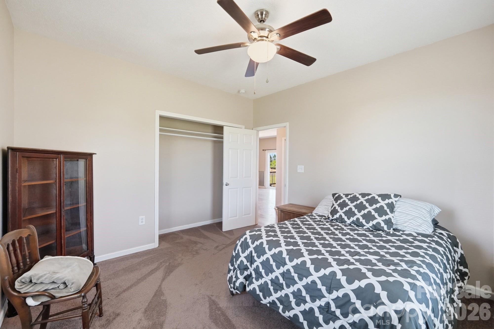 4415 Old Monroe Marshville Road Wingate, NC 28174 - Photo 18 of 28 a bedroom with a bed and a chandelier