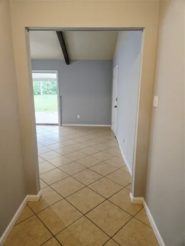 a view of a livingroom with an empty space and a window in it