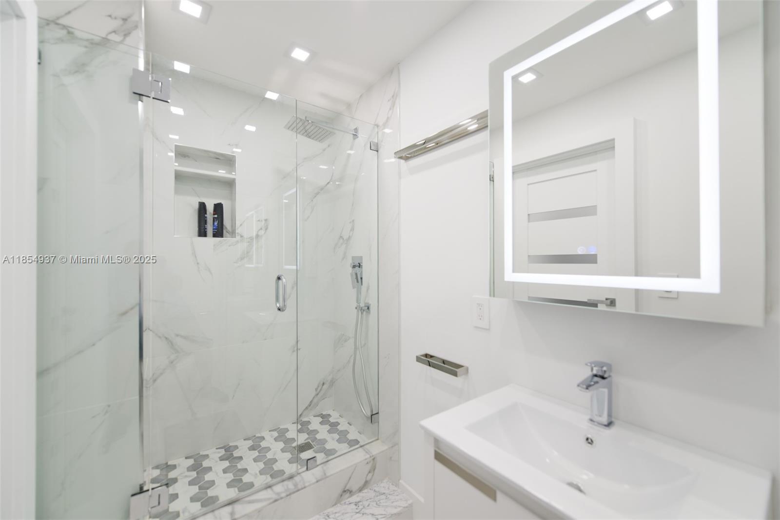 1980 South Ocean Drive, Unit PHM Hallandale Beach, FL 33009 - Photo 11 of 18 a bathroom with a sink shower and a mirror