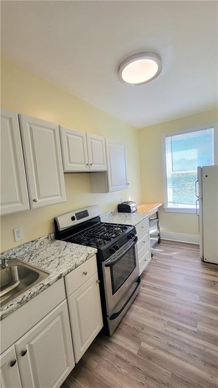 1003 Middle Glenshaw, PA 15116 - Photo 11 of 15 a kitchen with granite countertop a stove a sink and a refrigerator