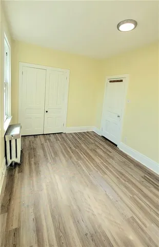 a view of a room with wooden floor