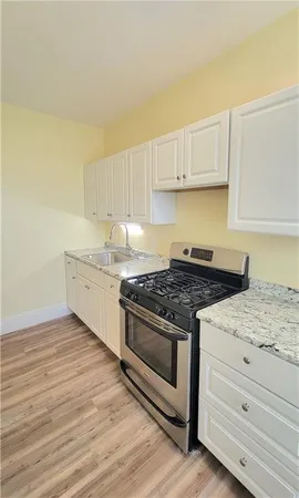 a kitchen with granite countertop a stove and a sink
