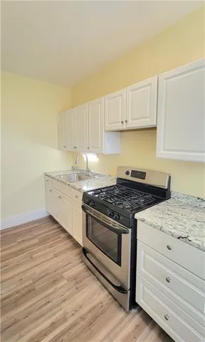 a kitchen with granite countertop a stove and a sink