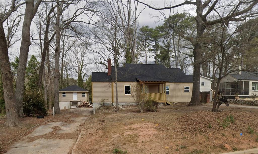 a view of a house with a yard covered in snow